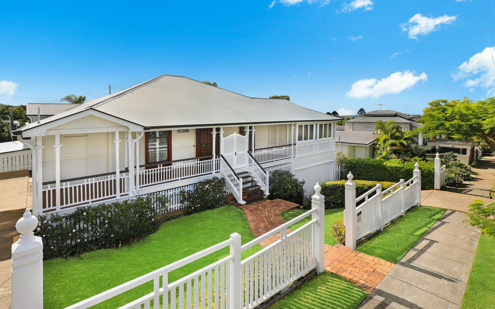 House with nice lawn and a white picket fence