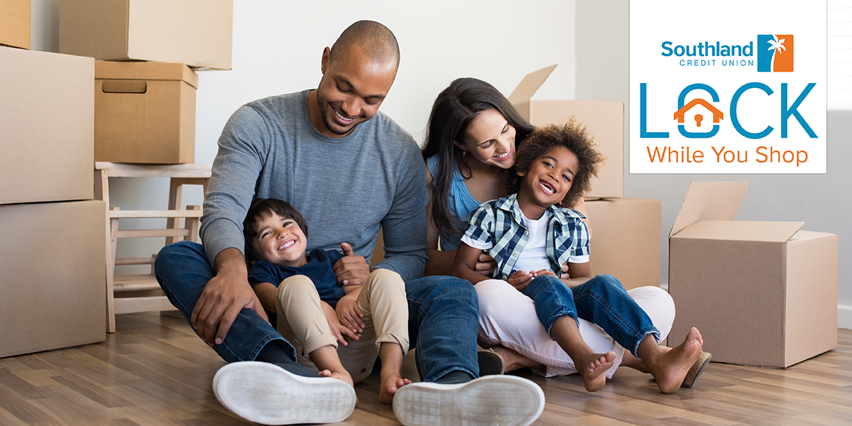 family sitting on the floor unpacking