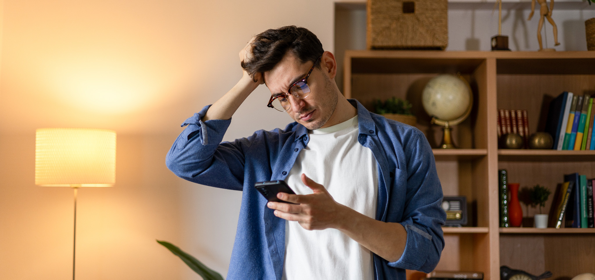A stressed individual looking at his phone.