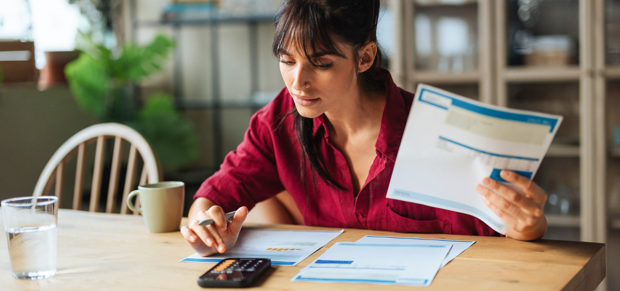 Woman managing finances, calculating bills and payments