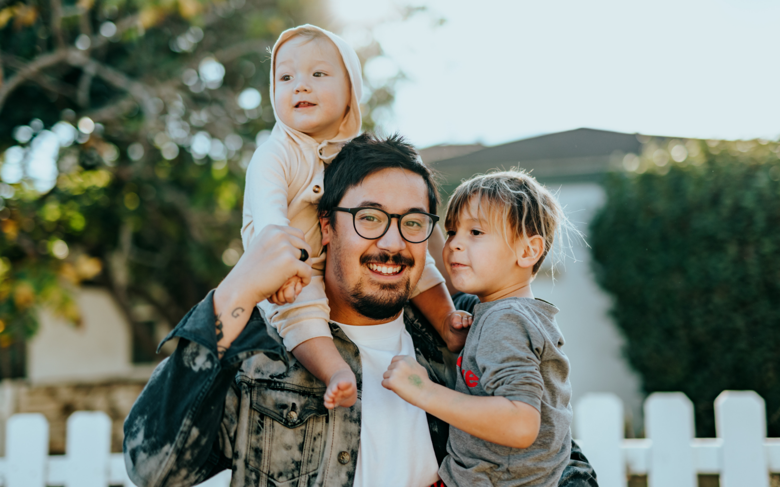 Man holding two kids