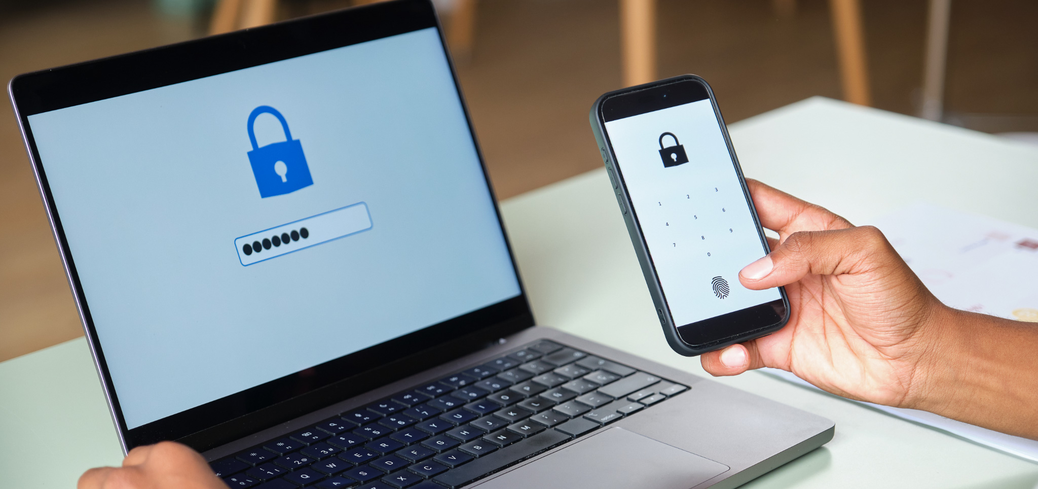 A person using two factor authentication system on smartphone and laptop