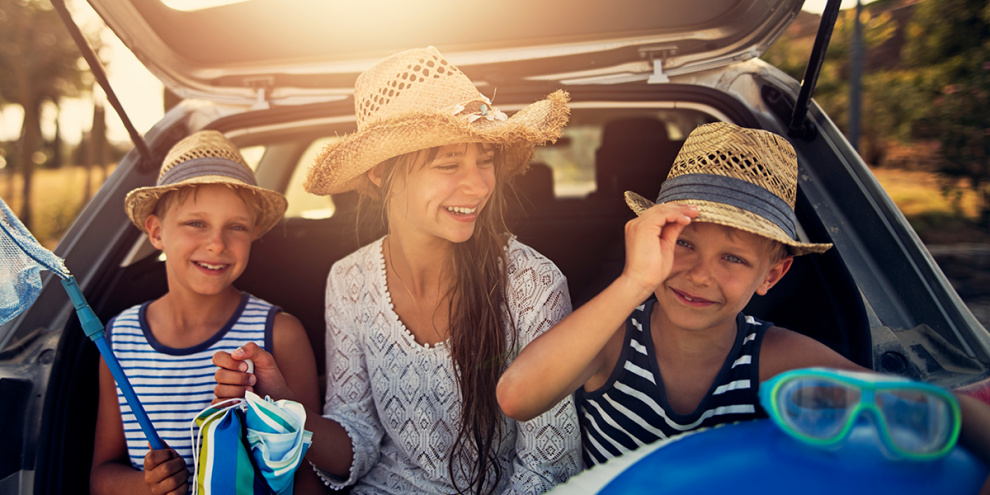 family in the back of a car