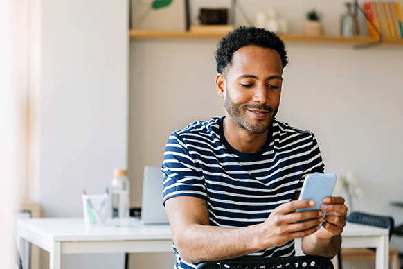 Man sitting looking at his phone